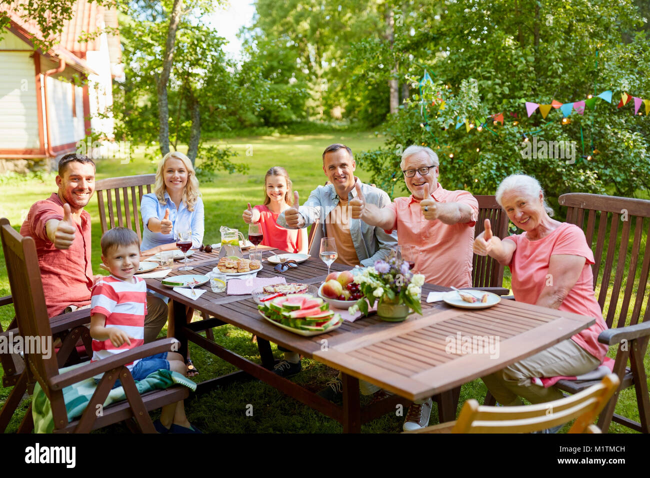 happy family having dinner or summer garden party Stock Photo