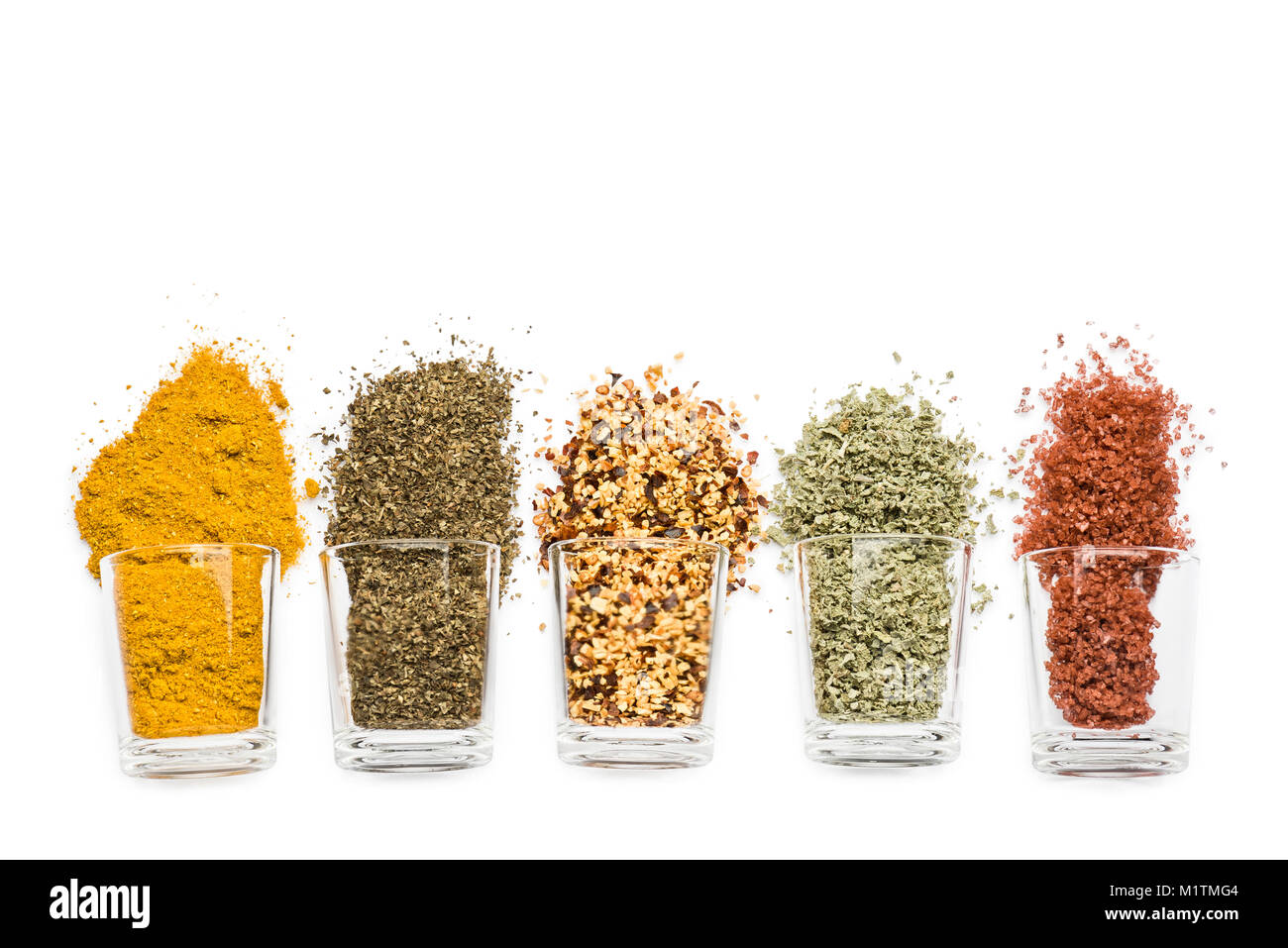 glass jars with various spices on white background with copy space Stock Photo