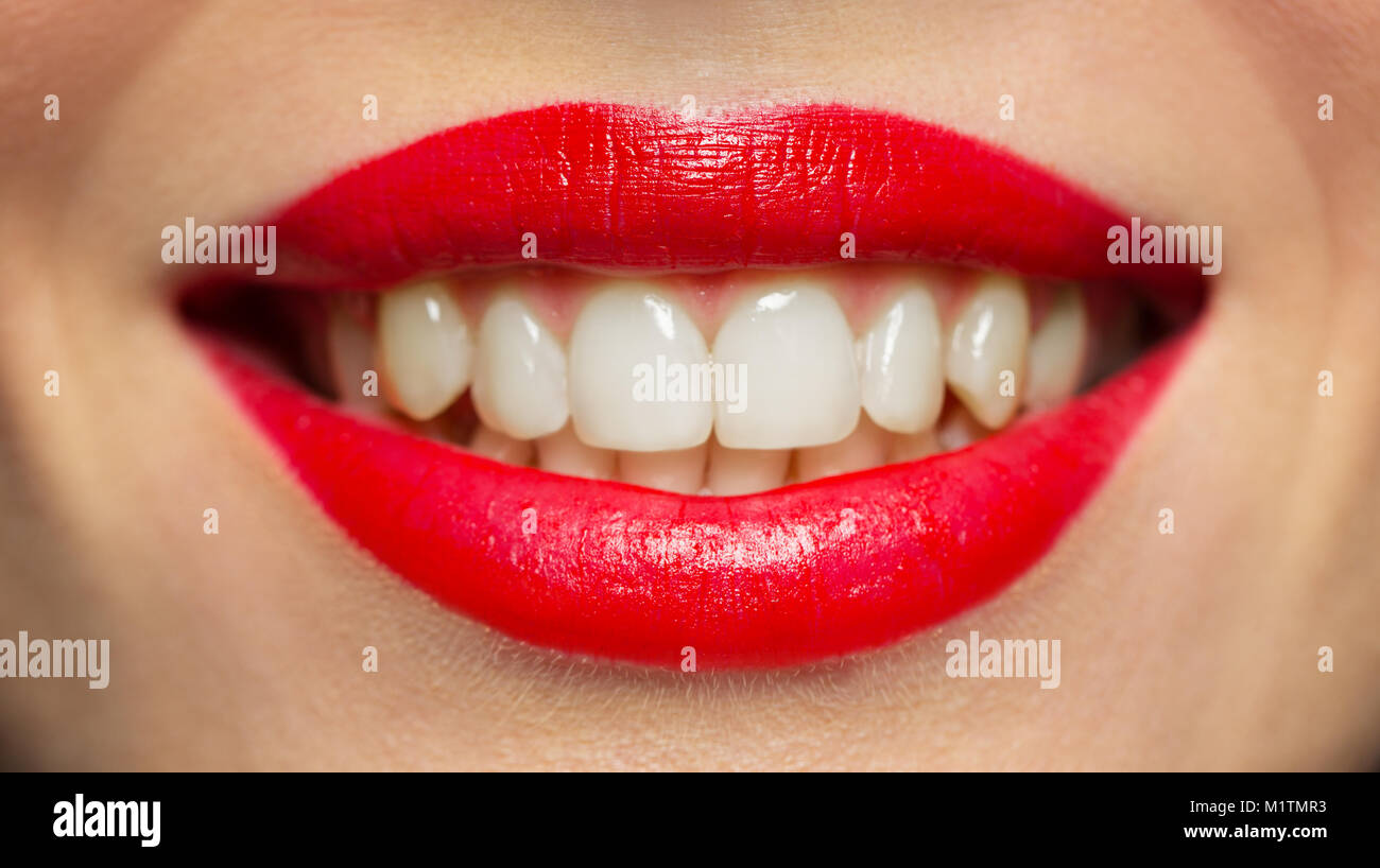 lips or mouth of smiling woman with red lipstick Stock Photo