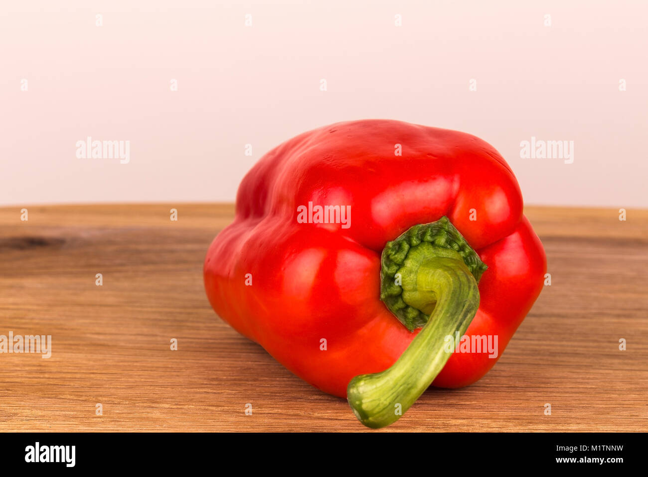 Red pepper, on a oak table taken as a close up with shallow depth of field. Stock Photo