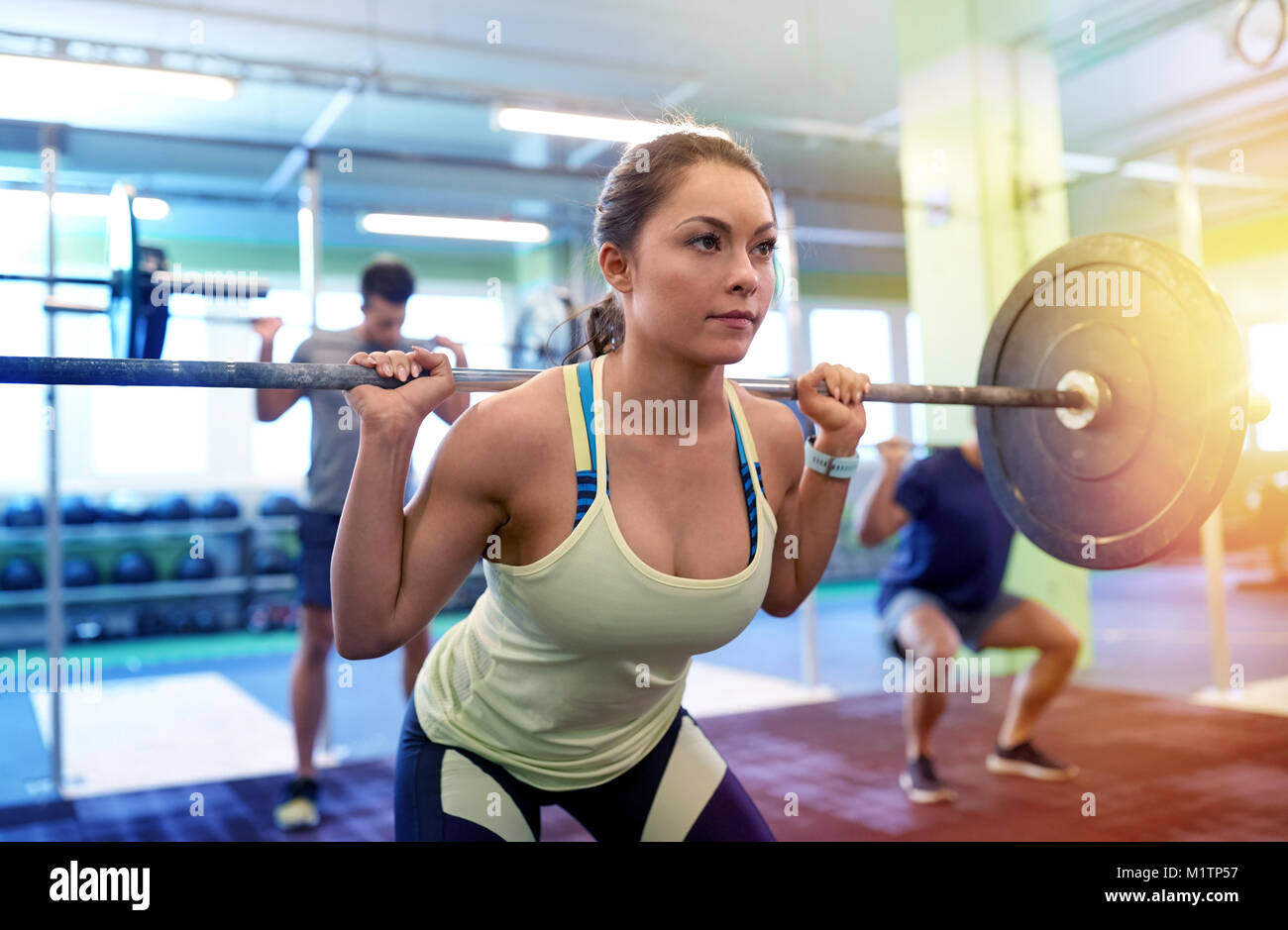 group of people training with barbells in gym Stock Photo