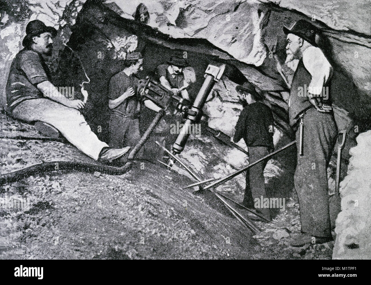 Halftone illustration of gold miners working 4154 feet below the surface in a South African mine, circa 1900. From an original image in How Other People Live by H. Clive Barnard, 1918. Stock Photo