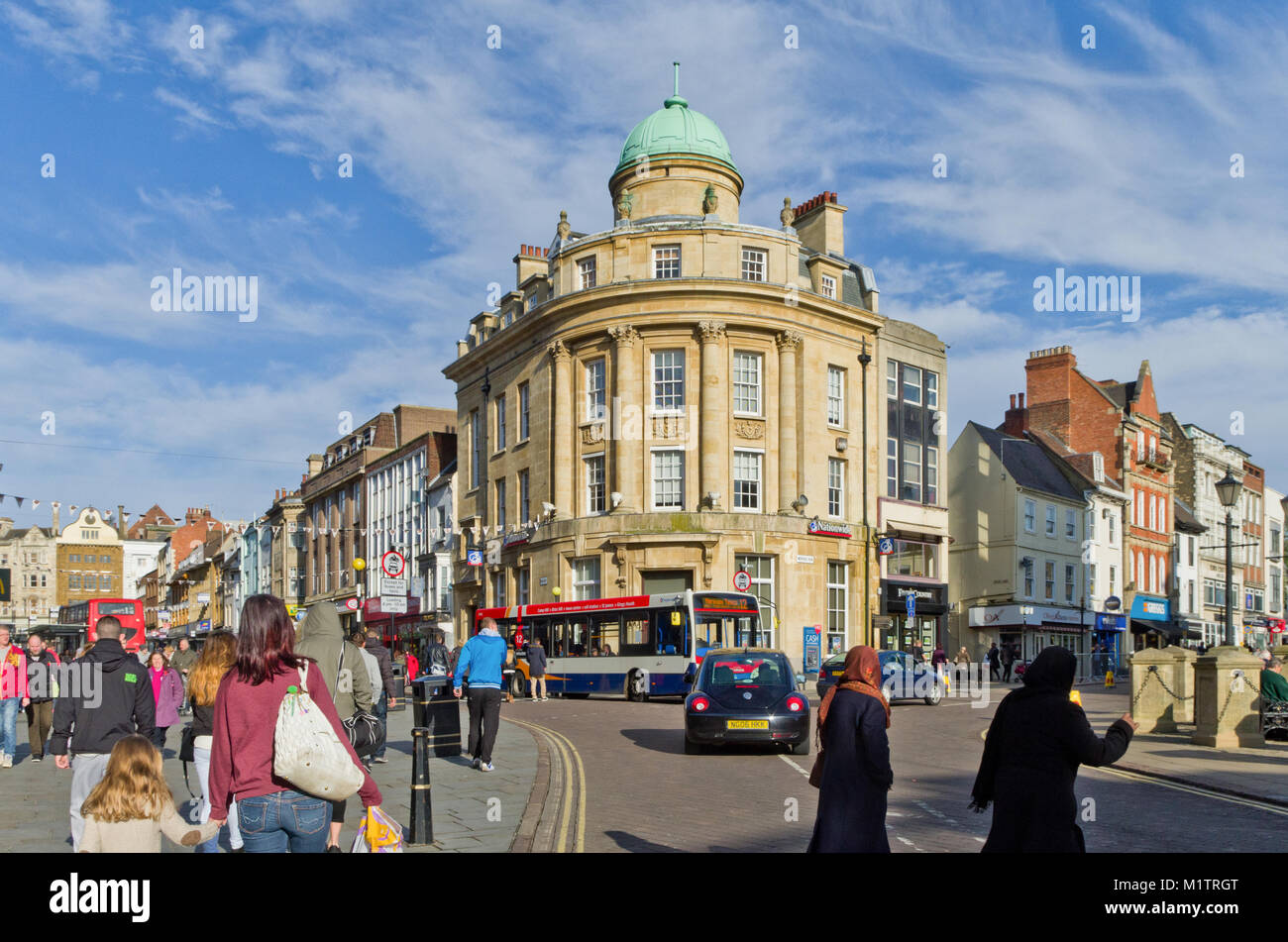 The busy centre of Northampton town, with the Drapery to the left and Mercers Row to the right and a collection of historic buildings; UK Stock Photo