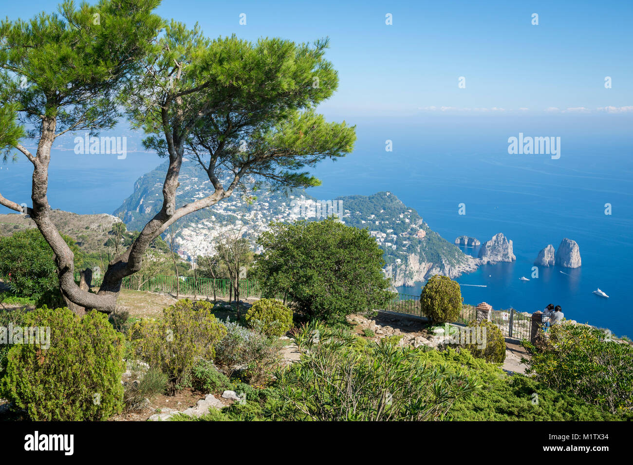 Bright scenic view of the iconic Faraglioni rocks from the cliffside ...