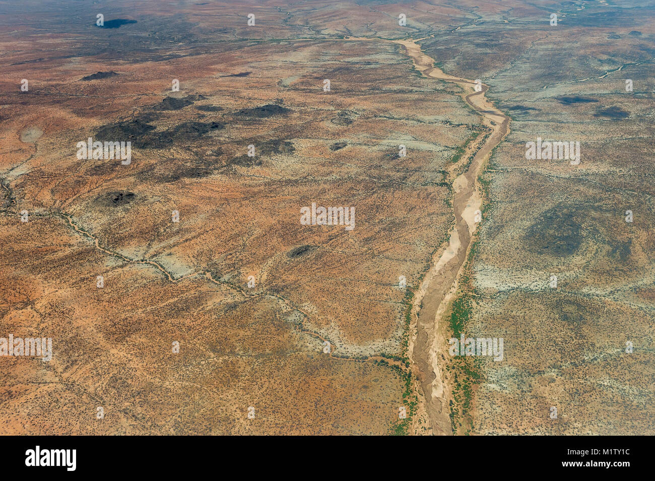 An aerial view of the almost dry Uaso Nyiro or Ewaso Ngiro River that flows through & divides the Buffalo Springs and Samburu National Reserves in nor Stock Photo