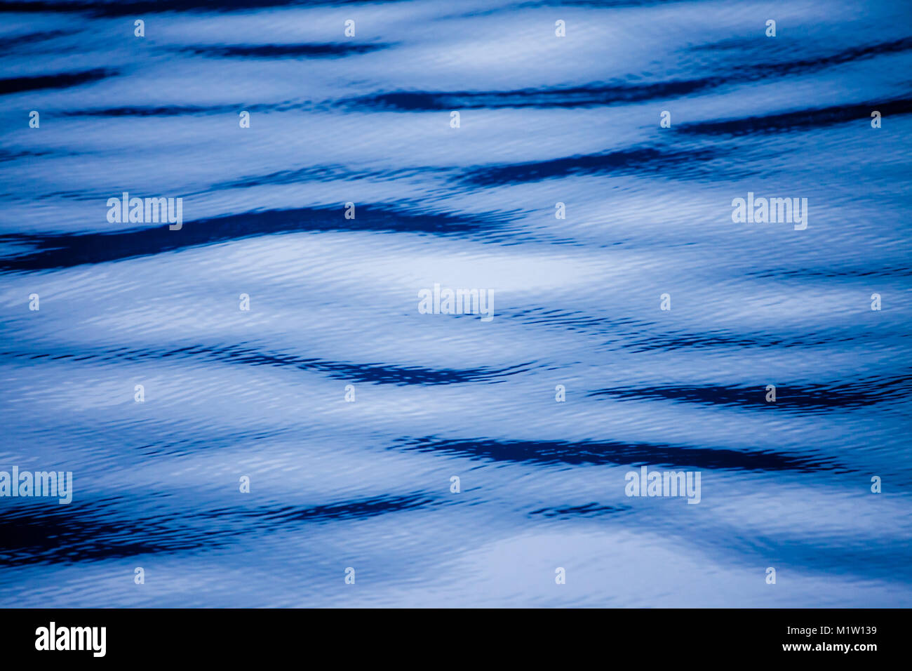 Blue abstract of ripples and waves on the surface of water Stock Photo ...