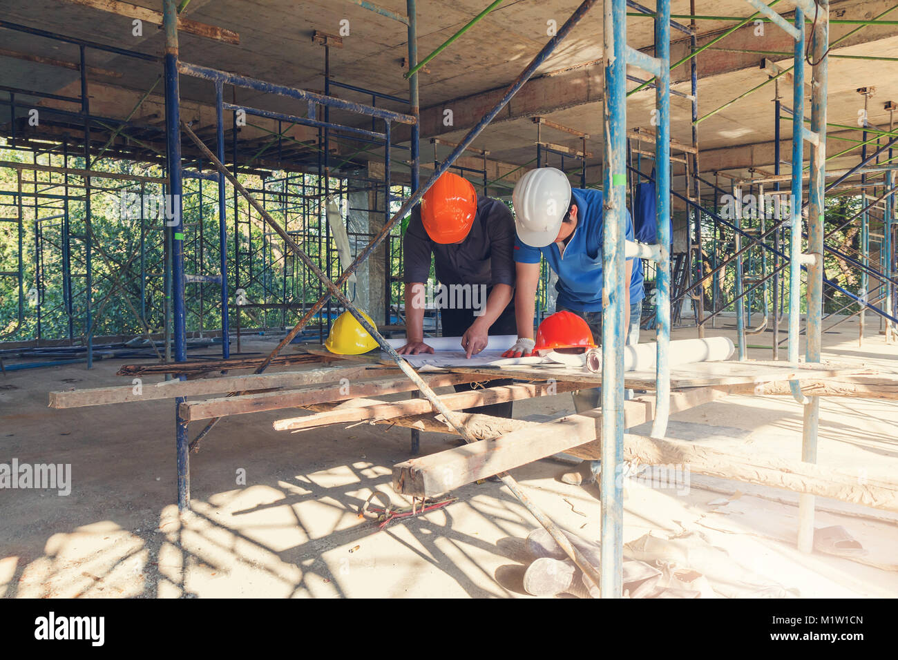 Construction concept of Engineer and Architect working at Construction Site with blue print Stock Photo