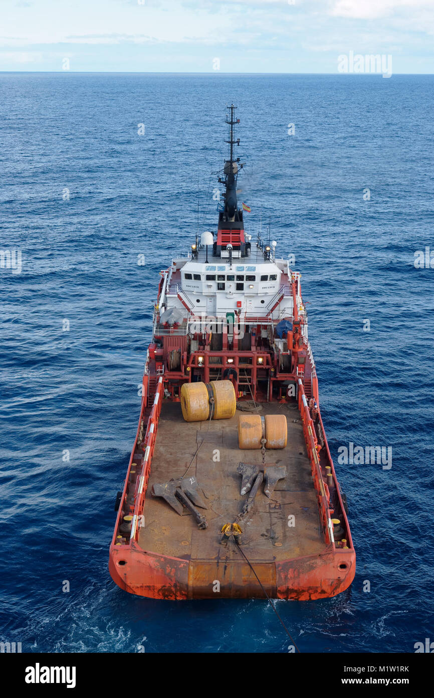An Anchor Handling Vessel with two submarine anchors and two buoys on the back deck. Stock Photo