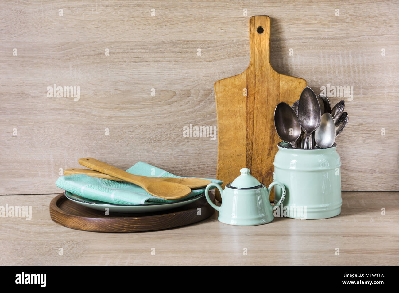 Turquoise and wooden vintage crockery, tableware, dishware utensils and stuff on wooden table-top. Kitchen still life as background for design. Image  Stock Photo