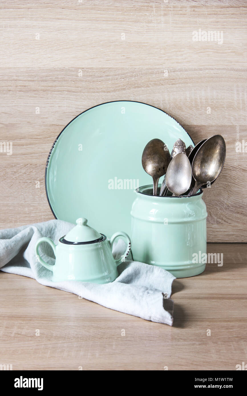 Turquoise crockery, tableware, dishware utensils and stuff on wooden