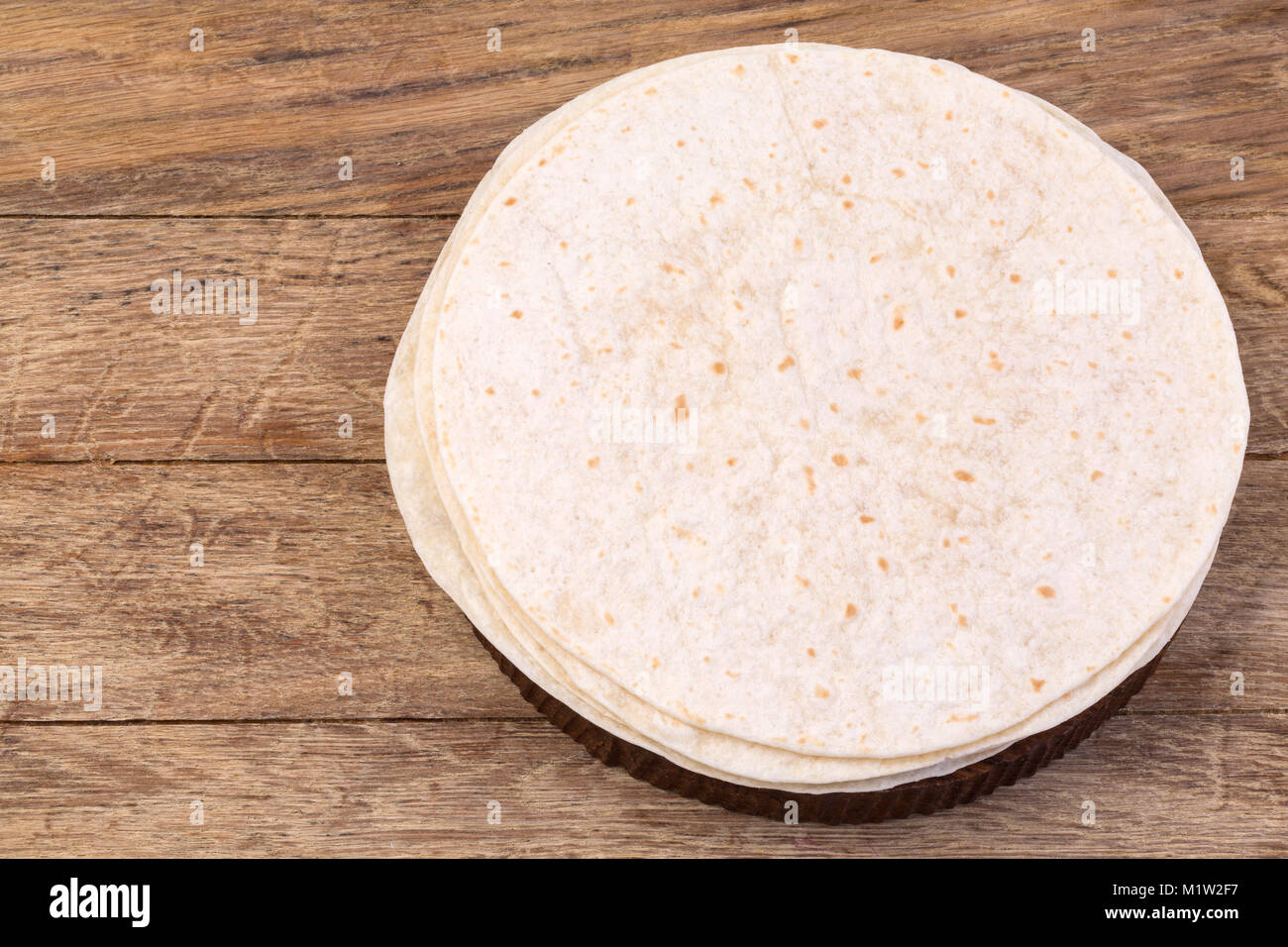 Stack of homemade whole wheat flour tortilla  on wooden table background Stock Photo