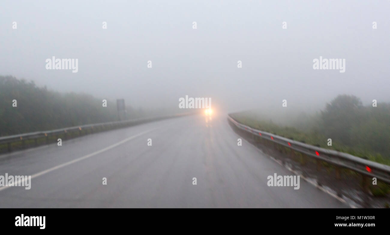 car in a country road with fog and low visibility Stock Photo - Alamy