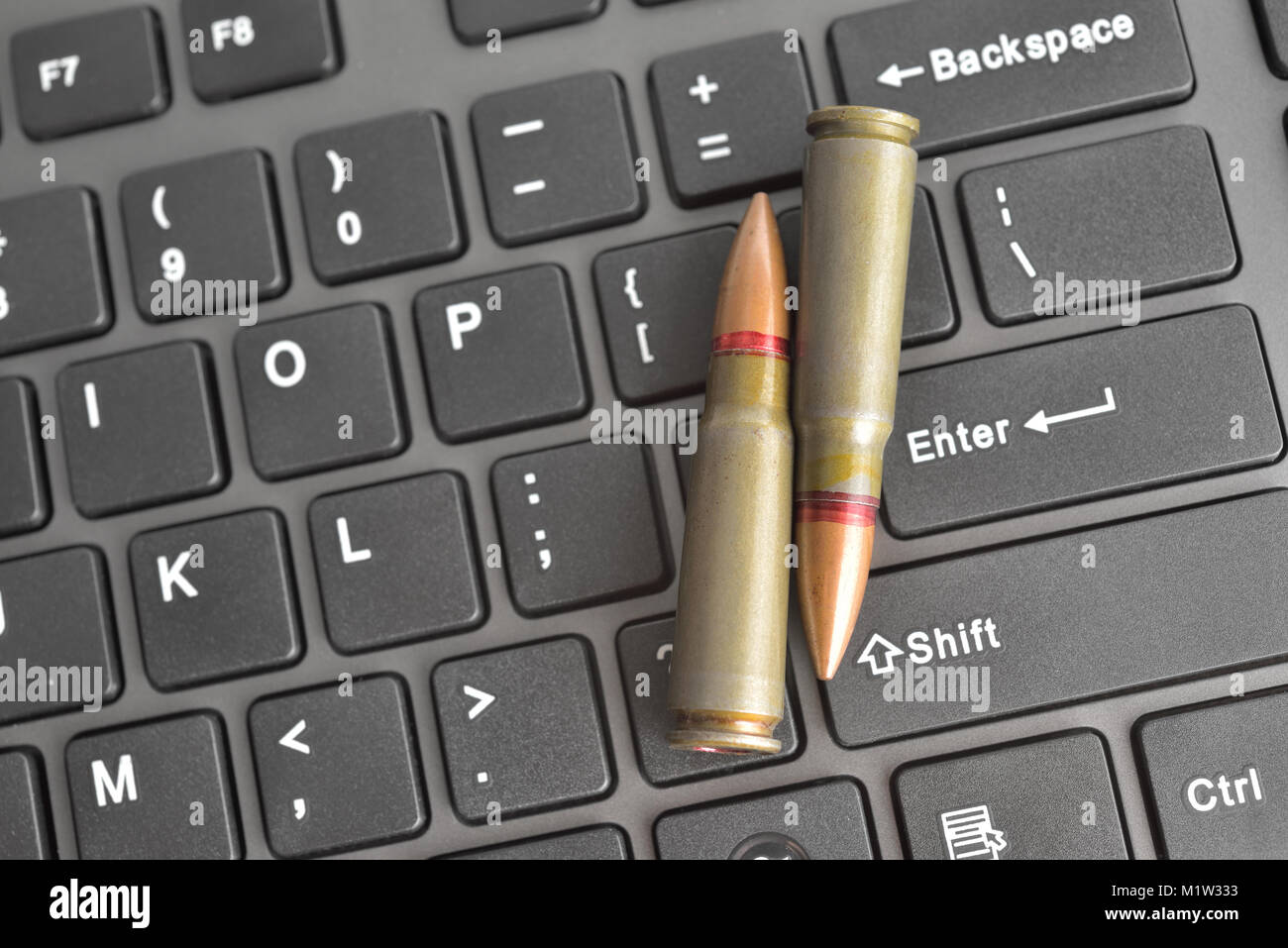 Internet dangers concept. Close up of bullets on computer keyboard Stock  Photo - Alamy