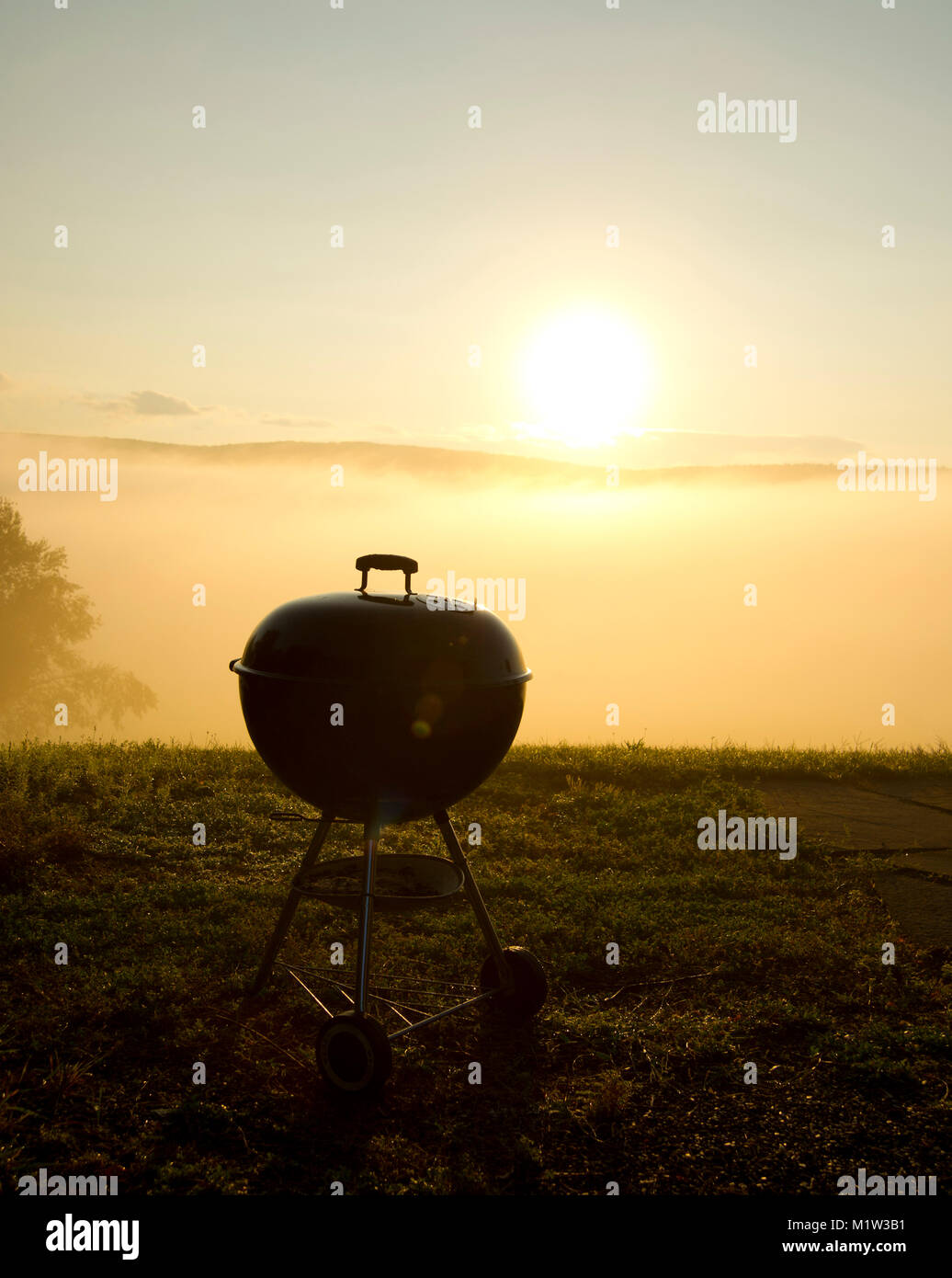 BBQ Grill at Misty Sunrise Stock Photo