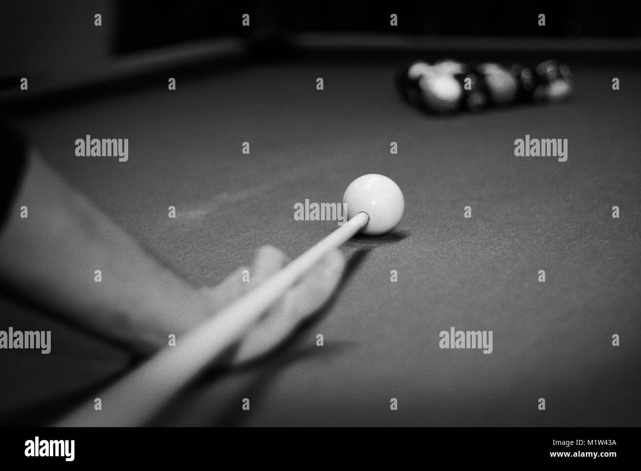 a man playing billiard pull black and white Stock Photo