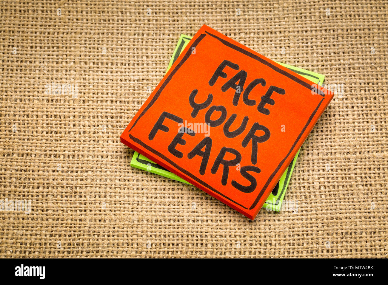 Fear Sticky Note face your fears reminde - handwriting on a sticky note against burlap ...