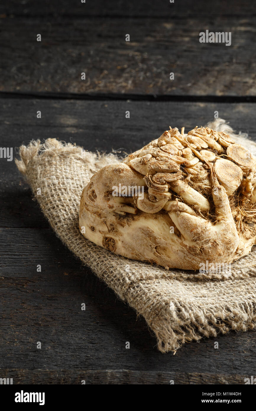 celery root and burlap on dark wooden background. Stock Photo