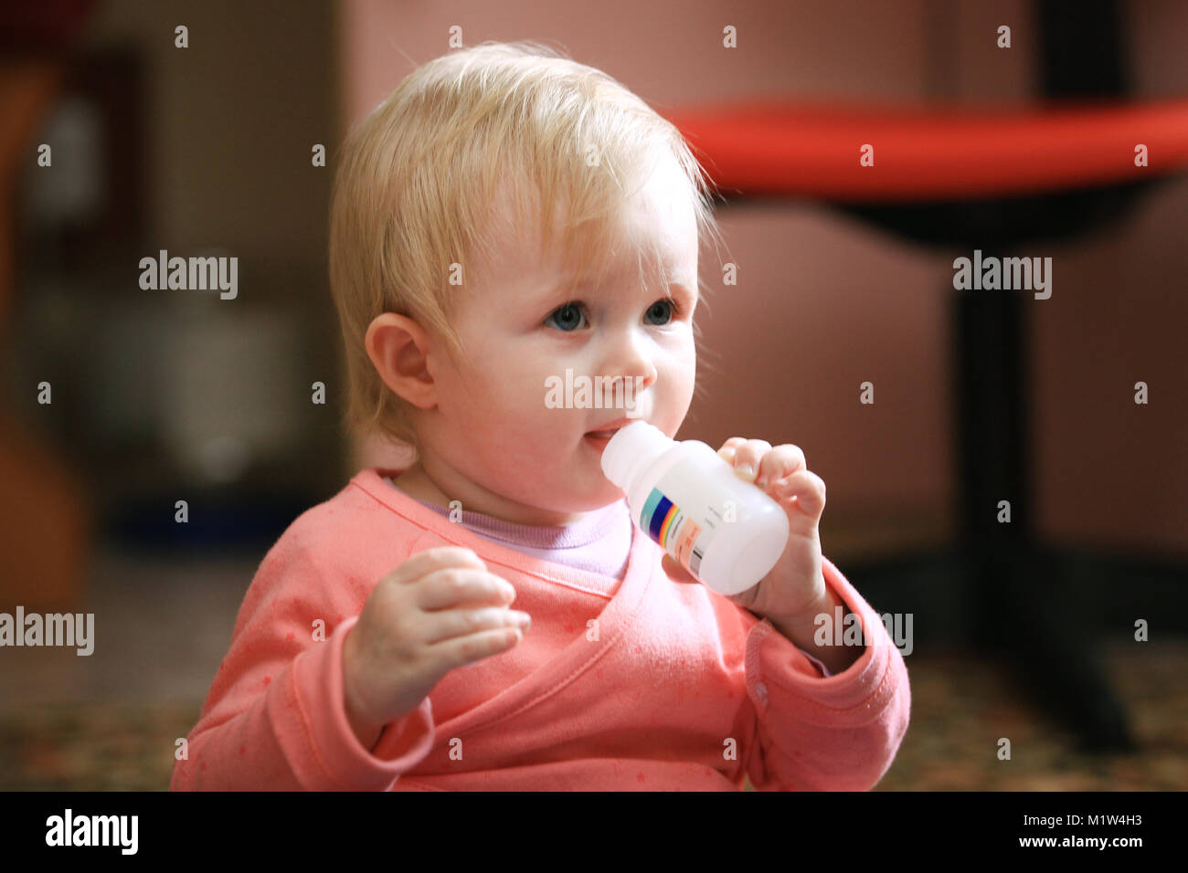 Baby girl toddler eats vitamins or pills at home Stock Photo Alamy