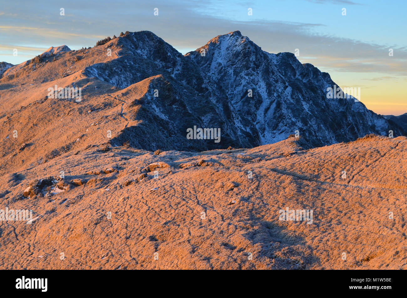 Snow and ice cover the highest peaks of Qilai mountains - Chilai Shan range, Taroko National park, northeastern Taiwan, in an early winter dawn Stock Photo
