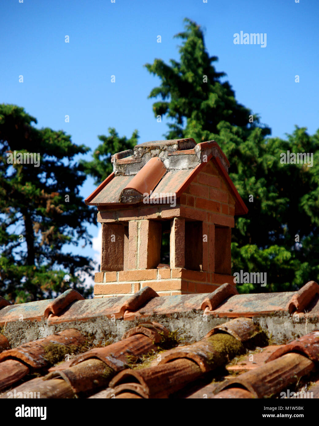 Chimney Built In Bricks On The Roof Made Of Clay Tiles Stock Photo