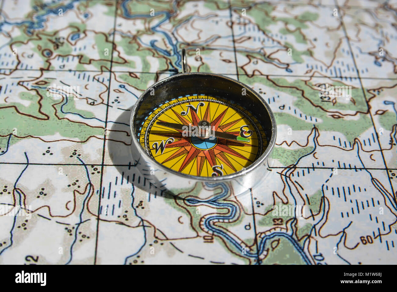 Compass on the map. Items necessary for orientation in travel Stock