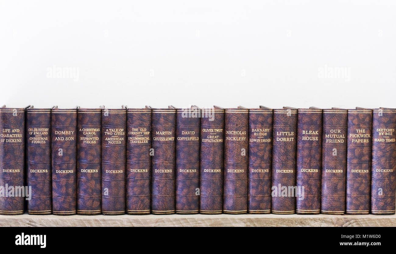 The works of Charles Dickens lined up on a shelf. Stock Photo
