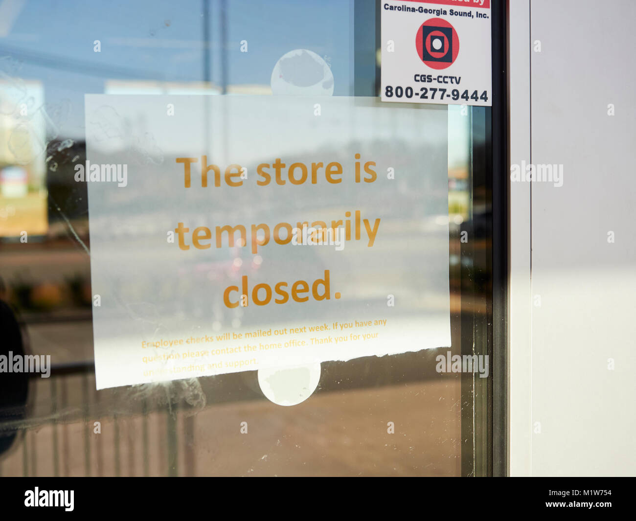 Store closed sign on the door to a shuttered or closed down business in Montgomery Alabama, United States. Stock Photo
