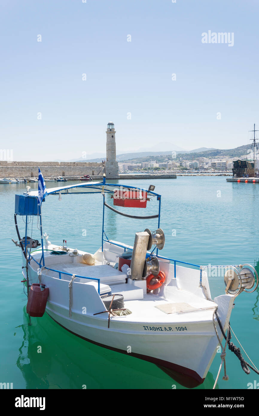 Fishing boat and Rethymnon Lighthouse, Rethymnon Harbour, Rethymnon (Rethimno), Rethimno Region, Crete (Kriti), Greece Stock Photo