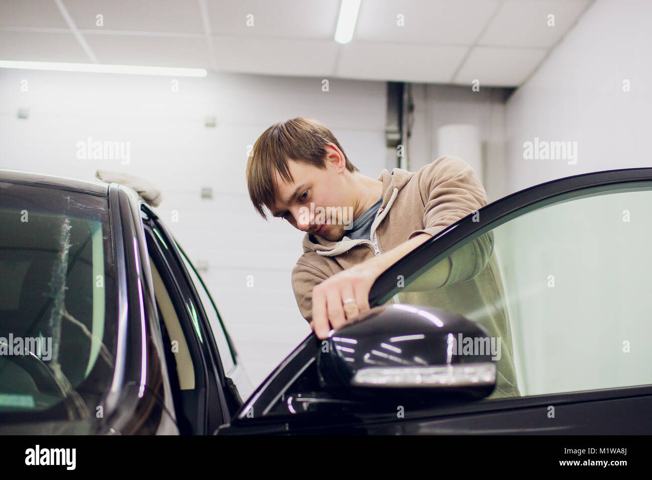 Car mirror man repair,Car accident broken side mirror. Black Stock