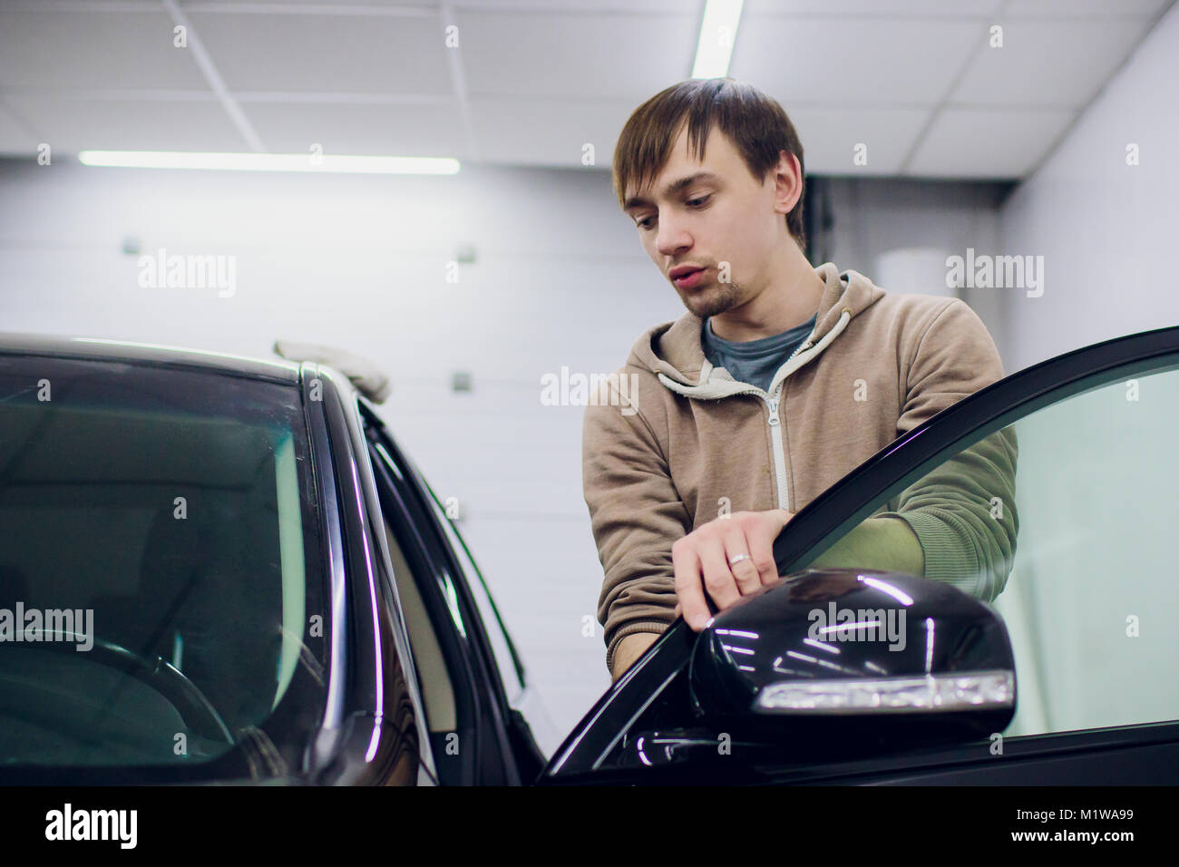 Car mirror man repair,Car accident broken side mirror. Black Stock