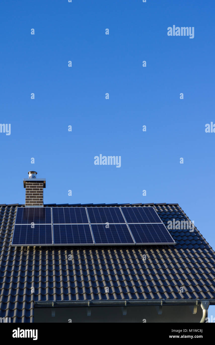 Brand new photovoltaics on house roof with chimney and blue sky Stock ...