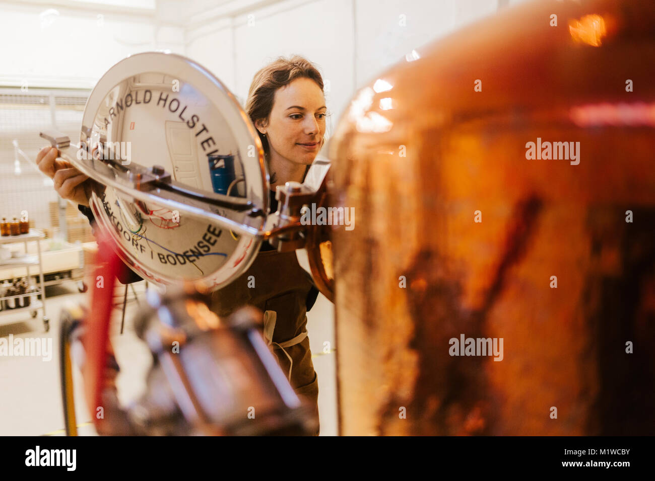 Worker at gin distillery in Sweden Stock Photo Alamy