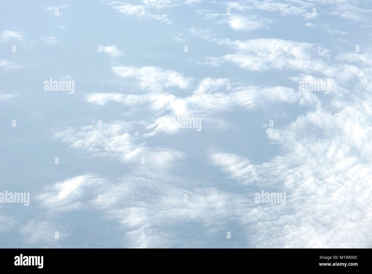 Aerial view of blue sky with soft fluffy white clouds. The view from ...