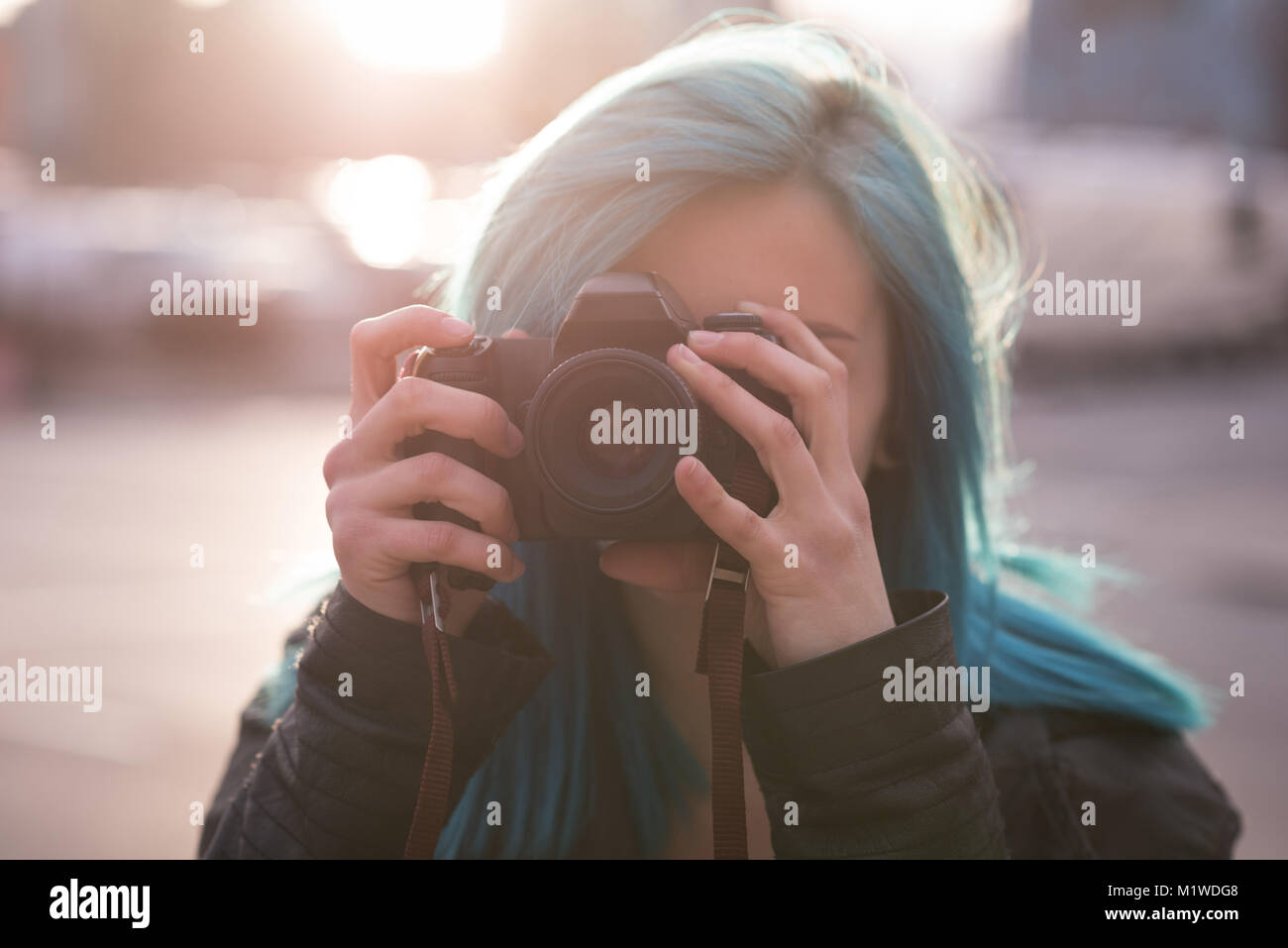 Woman photographing with camera in city street Stock Photo - Alamy