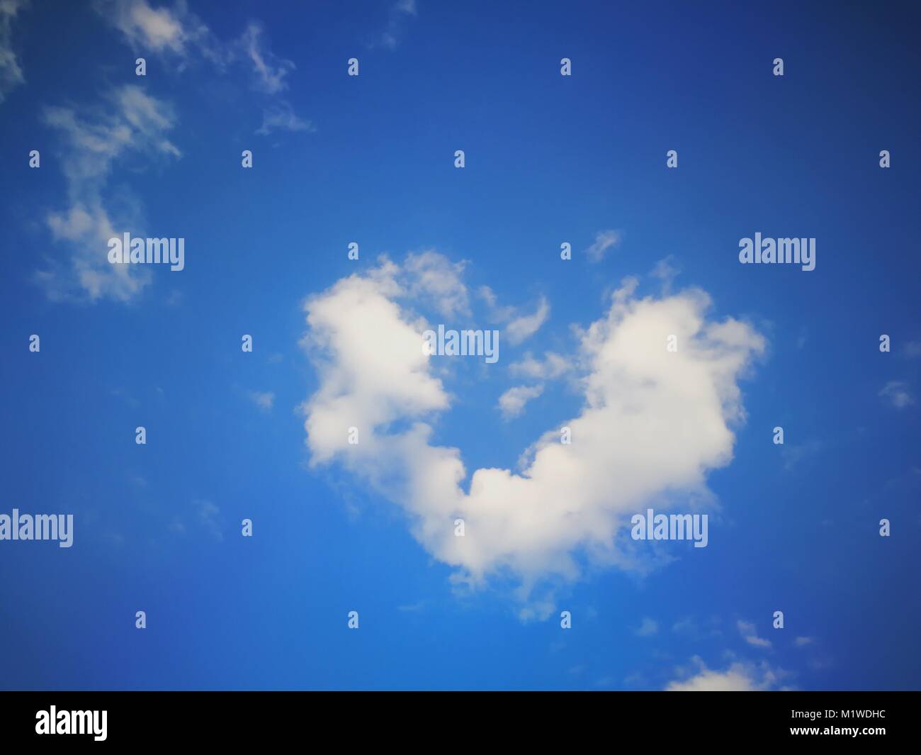 Fluffy heart shape clouds in blue sky for Valentine's background Stock ...
