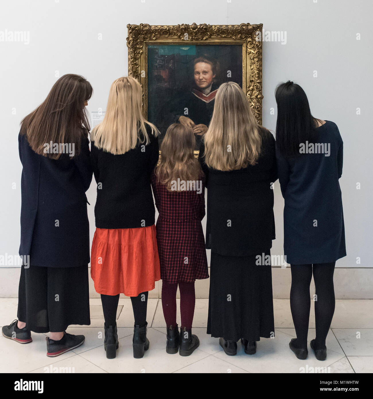 London, UK. 2nd Feb, 2018. Staff members, joined by Stella Cartwright, aged 9, view a portrait of Millicent Fawcett, by Annie Swynnerton, on display at Tate Britain to mark the centenary of the women's right to vote, as embodied in the Representation of the People Act. Millicent Fawcett was a leading figure in the suffragist movement, campaigning for the right for women to vote in the UK, while Annie Swynnerton was one of the first women elected to be a member of the Royal Academy of Arts. Credit: Stephen Chung/Alamy Live News Stock Photo