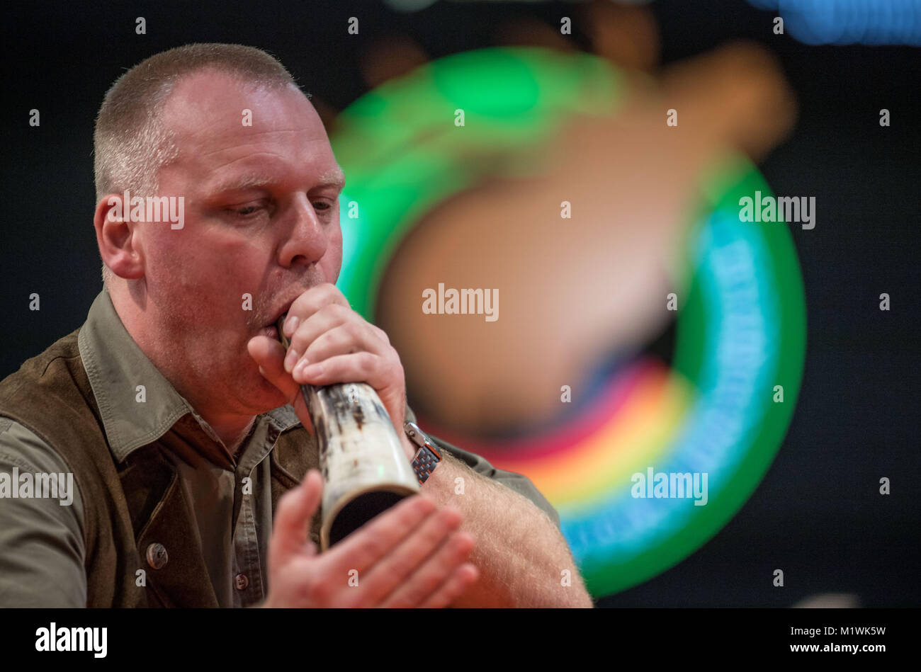 Dortmund, Germany. 2nd Feb, 2018. Winner Enrico Braun from Wittstock in Brandenburg blows into his instrument at the 20th German Championship of Stag-Calling in Dortmund, Germany, 2 February 2018. The art of stag-calling is part of the traditional vocation of the huntsman. Credit: Bernd Thissen/dpa/Alamy Live News Stock Photo