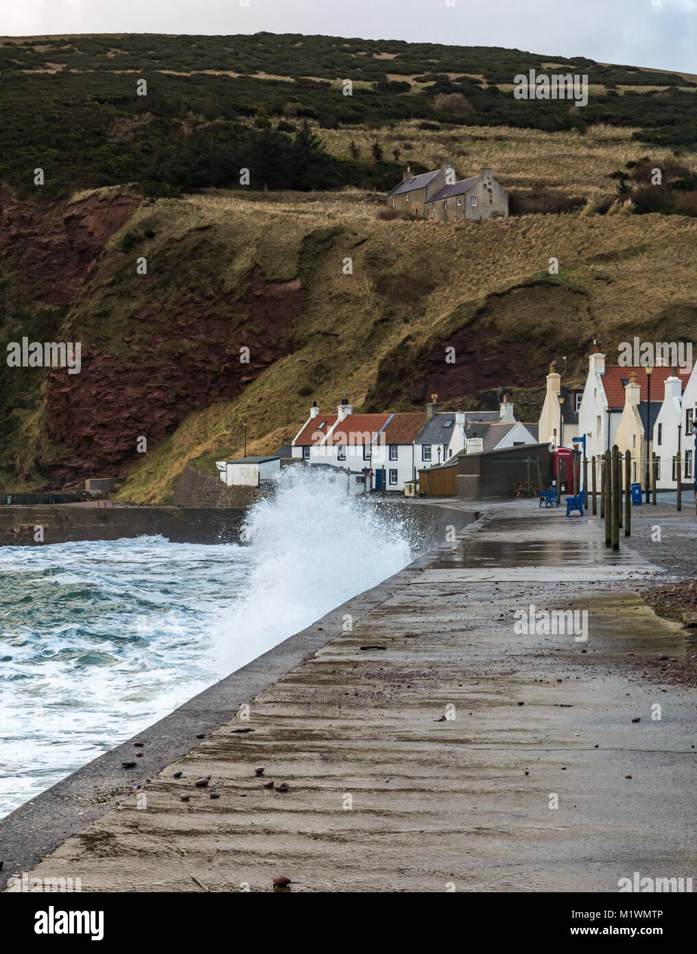 Pennan, Aberdeenshire, Scotland, United Kingdom, 2nd February 2018. The strong winds create a surge in the North Sea along the Northeast coast of Scotland, with large waves splashing against the promenade in the picturesque village, famous for being a film location for the movie 'Local Hero' Stock Photo