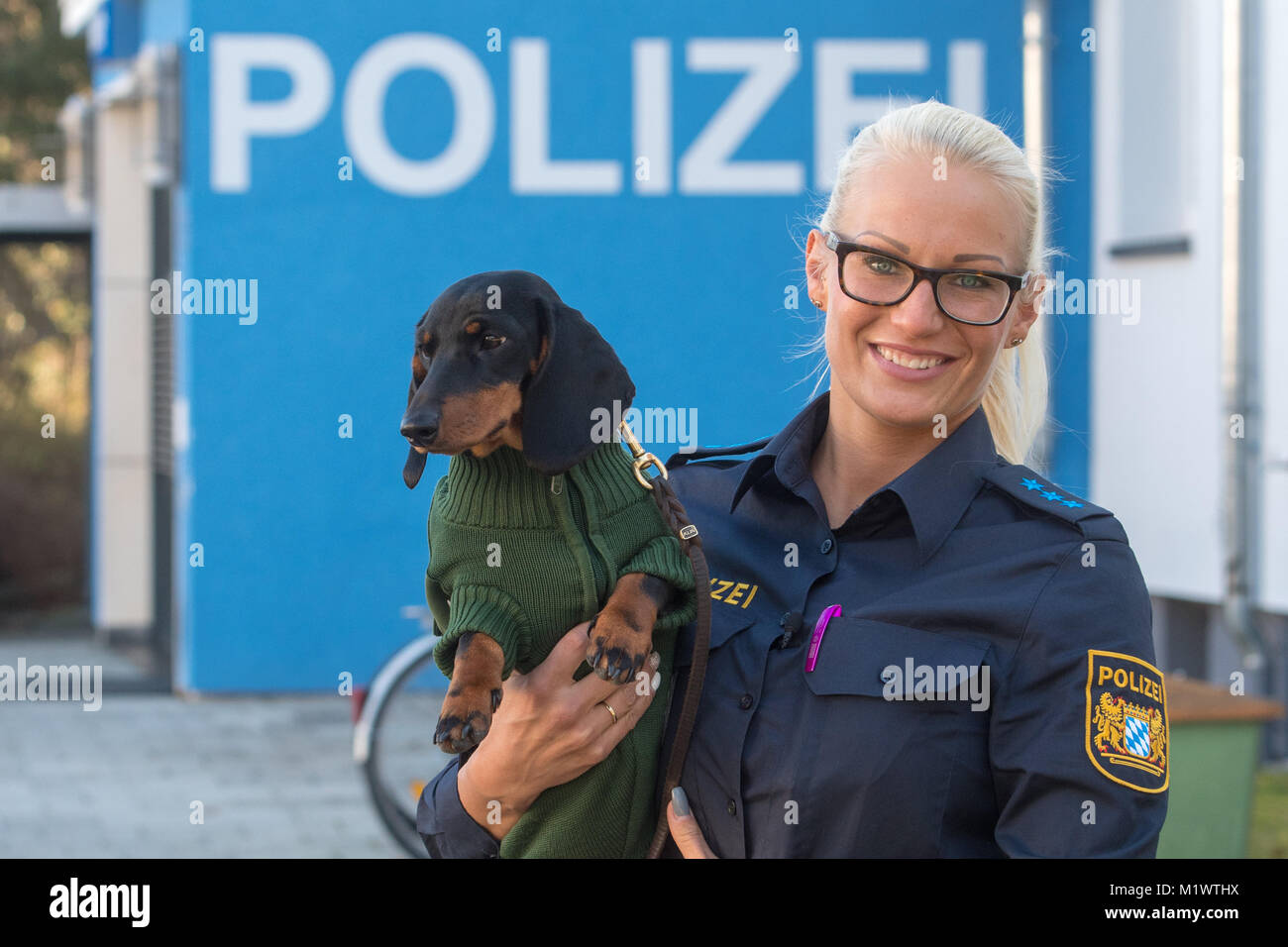 Waldkraiburg, Germany. 31st Jan, 2018. Police officer Marina Gutte holds  dachshund Olga in Waldkraiburg, Germany, 31 January 2018. The dog is  wearing an old refashioned police sweatshirt. Credit: Armin  Weigel/dpa/Alamy Live News