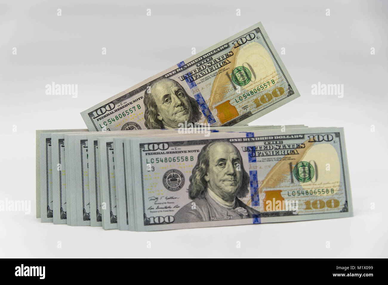 a stack of us 100 dollars cash with white background Stock Photo - Alamy