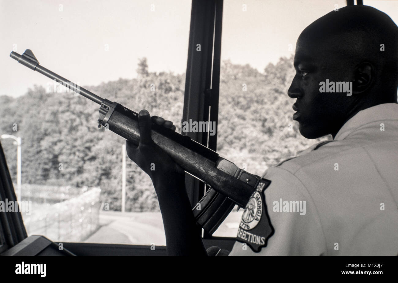 A tower guard holds his sniper rifle inside a state prison in Georgia, USA. Stock Photo