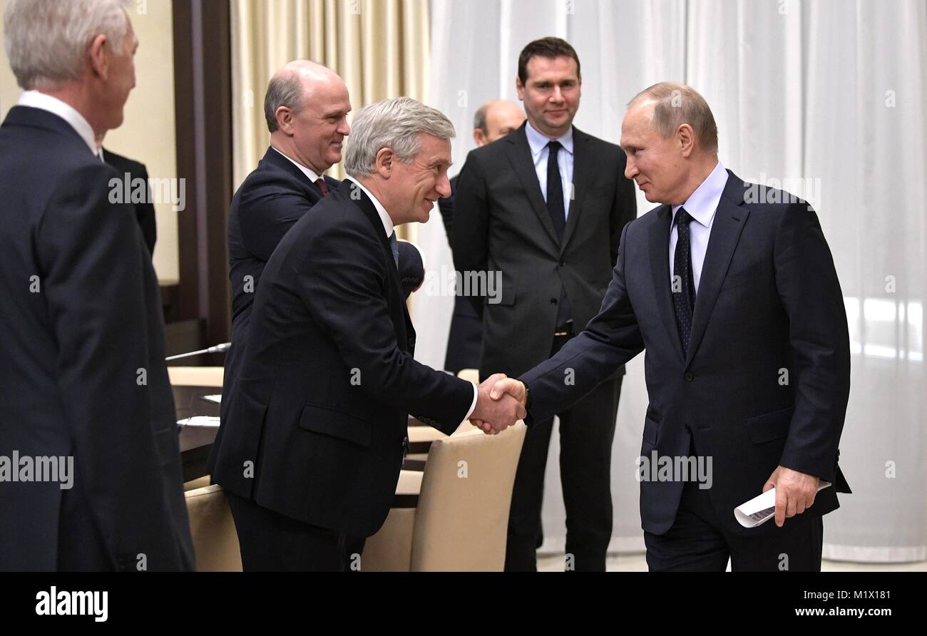 Russian President Vladimir Putin, right, greets Volga Group founder Gennady Timchenko, left, during a meeting with the Economic Council of the Franco-Russian Chamber of Commerce and Industry January 31, 2018 in Novo-Ogaryovo, Moscow, Russia. Stock Photo