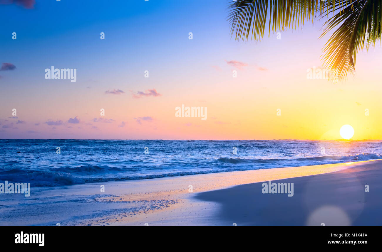 Art Beautiful sunset over the tropical beach Stock Photo - Alamy
