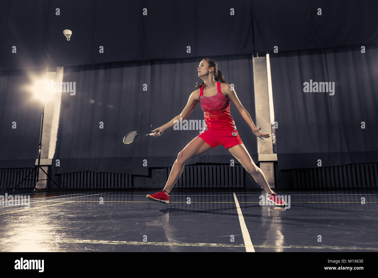 Young woman playing badminton at gym Stock Photo Alamy