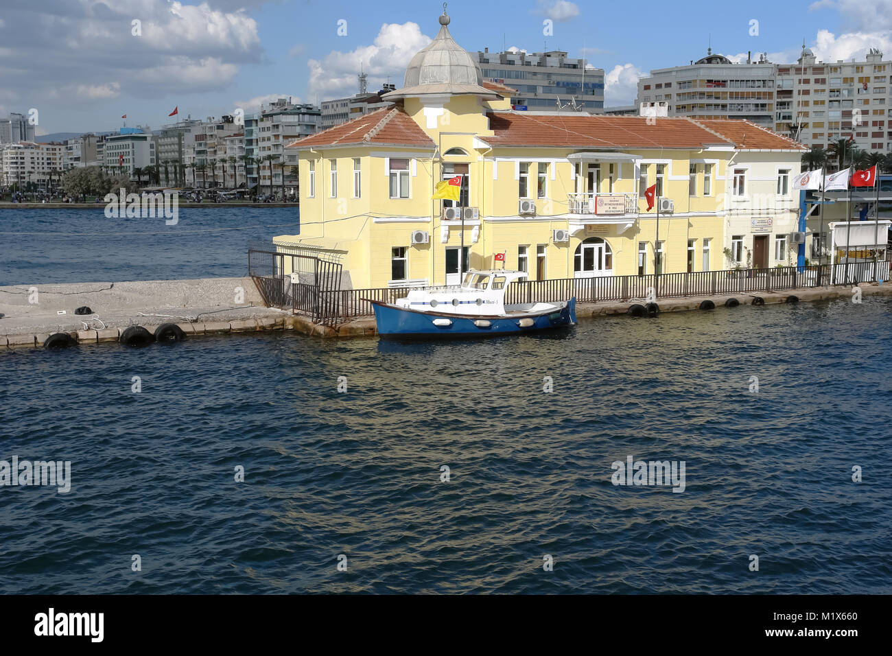 Izmir, Turkey - April 21, 2012: Yellow building of the Passport Ferry Terminal in Izmir Bay. Passport Ferry Terminal, which is one of the historical p Stock Photo