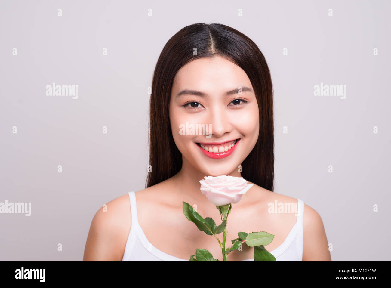 Asian girl flower freshness relaxation concept. Beauty woman with pink rose Stock Photo