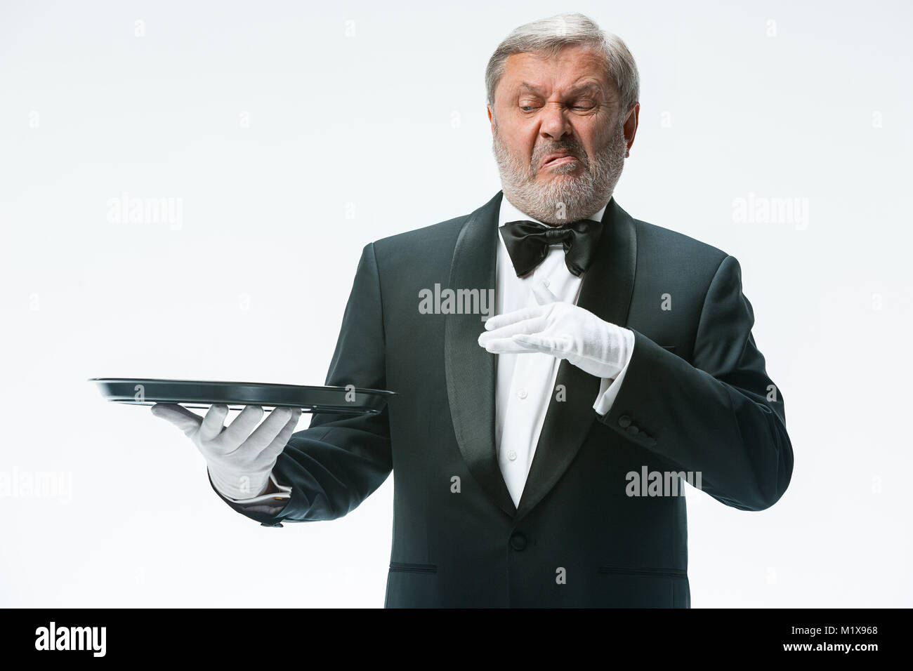 Senior waiter holding tray Stock Photo