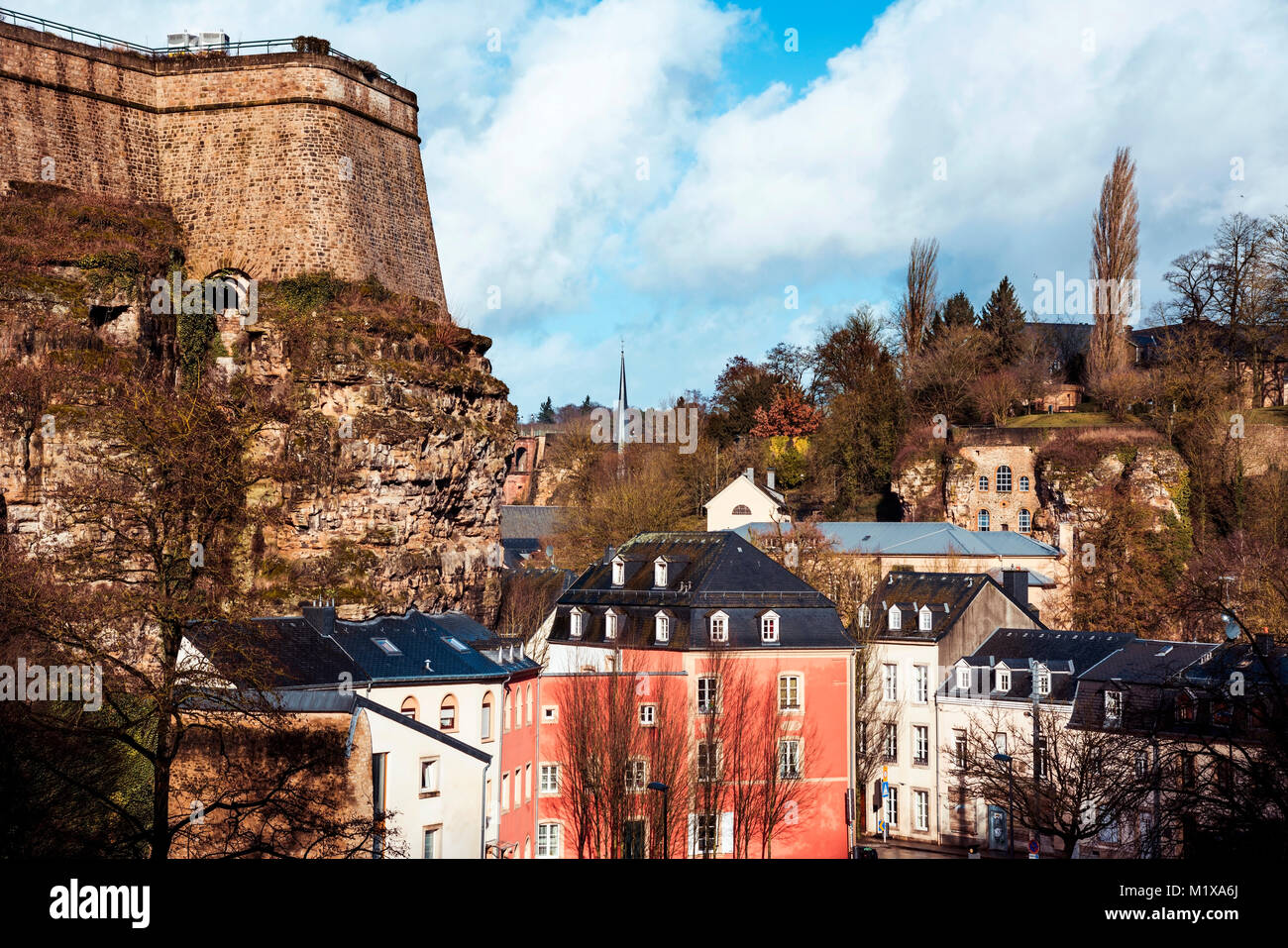 a view of the Grund Quarter in Luxembourg City, Luxembourg, with its typical houses with black slate roofs and highlighting the walls of the ancient f Stock Photo