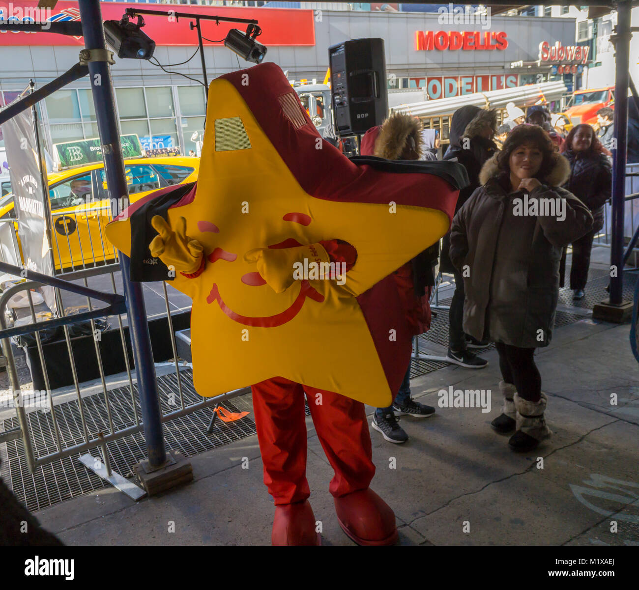 The Carl's Jr. mascot entertains the crowd on line waiting to get into