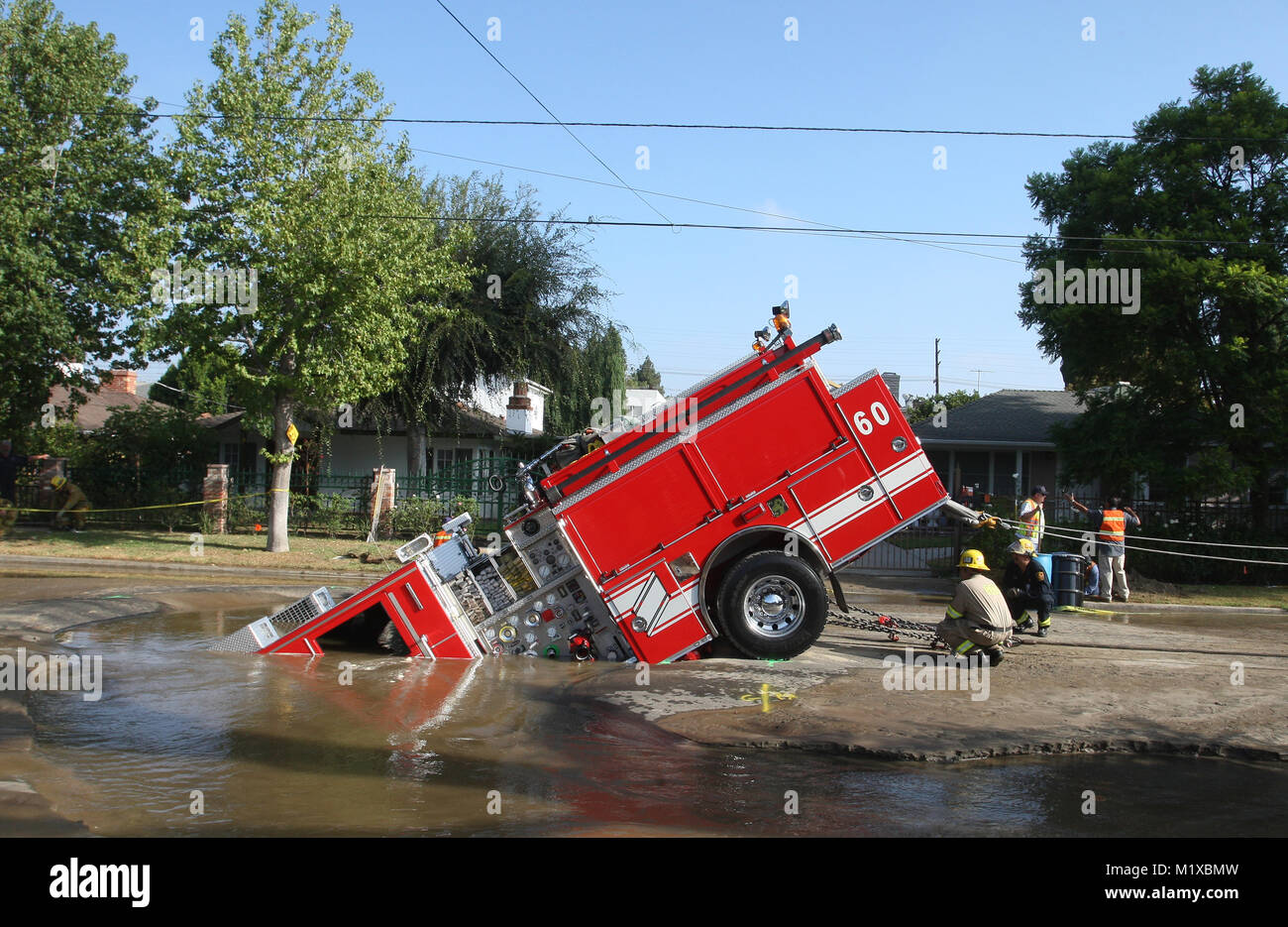 A Los Angeles Fire Department fire engine plunged into a sink hole in Valley Village, California Stock Photo